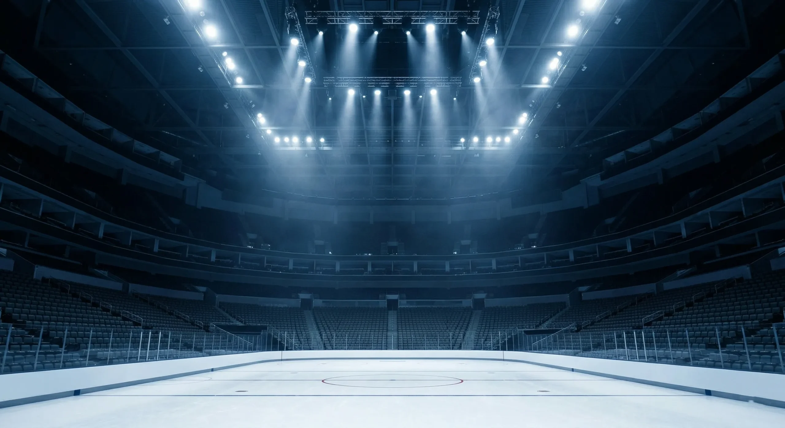 Empty hockey arena with dramatic overhead lighting — cinematic sports aesthetic